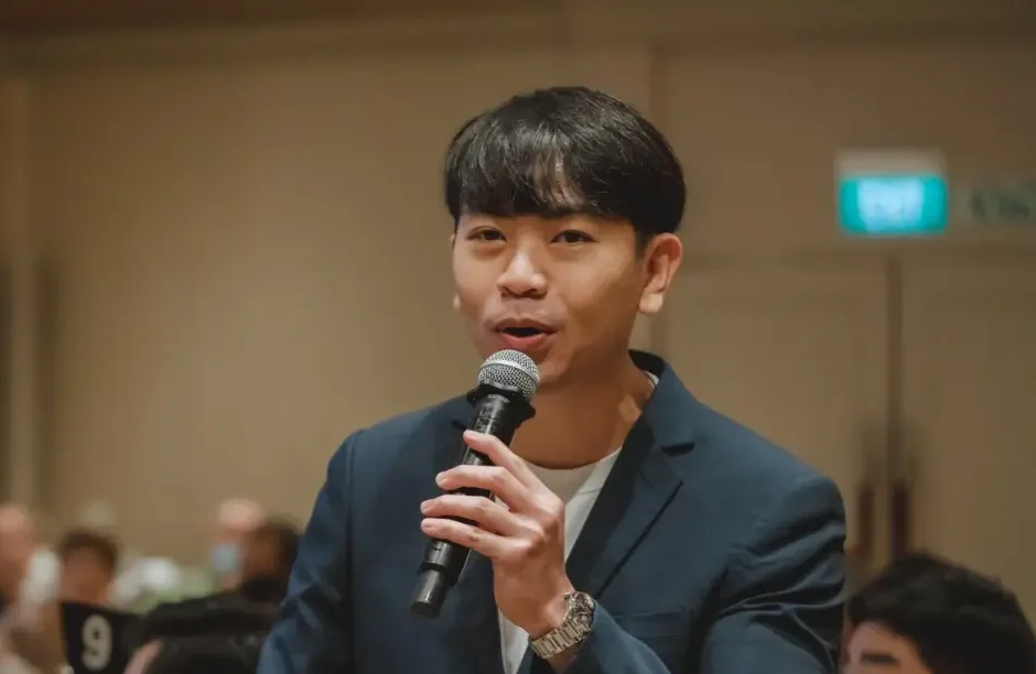 Emcee Rayson Soh hosting live with a microphone at a Singapore event