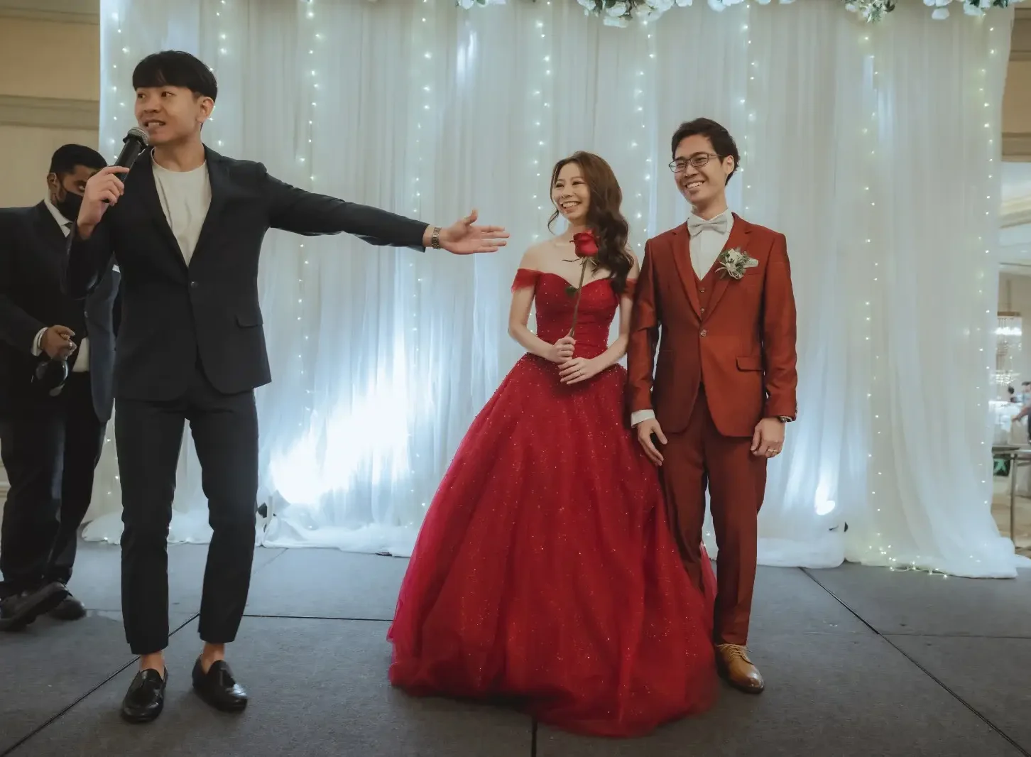 Emcee Rayson Soh hosting live on stage, presenting the couple at a Singapore wedding